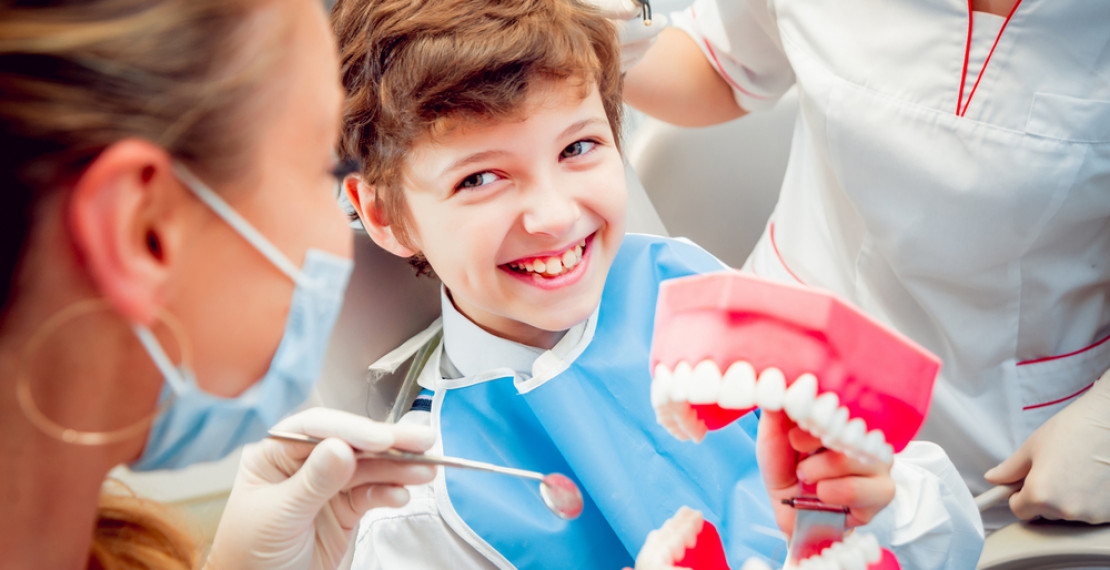 Kid with Model Teeth Ortho